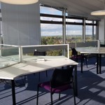 Student study area. Triangular desks with chairs and large windows with view of Oxford