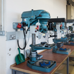 Row of several large drilling machines in a lab