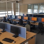 Several long desks with many desktop computer stations