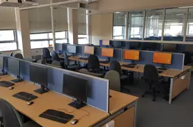 Several long desks with many desktop computer stations