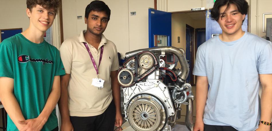 Students standing by a motor