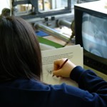 Student sketching results from a monitor