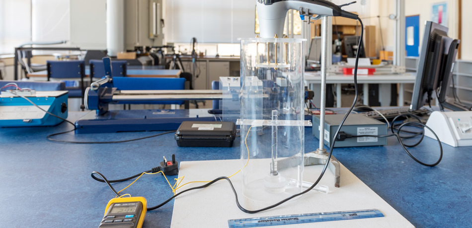 Lab equipment set up with hair dryer pointing at lab bench