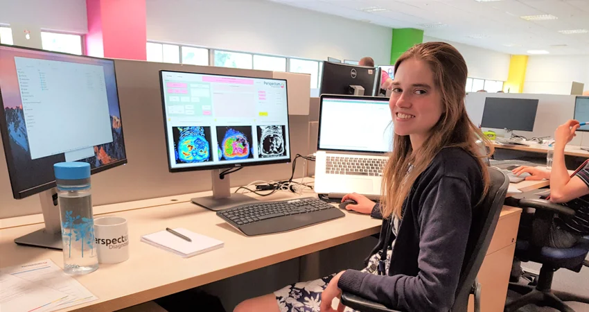 DPhil candidate Elisabeth Pickles at her desk doing research into the use of MRI scanning to monitor disease