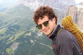 Young man smiling on mountain top