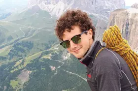 Young man smiling on mountain top