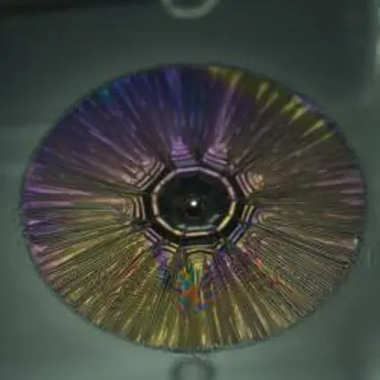 A striking pattern of radial wrinkles captured by a high speed video camera when steel spheres were dropped onto ultra-thin sheets of polystyrene, floating on water