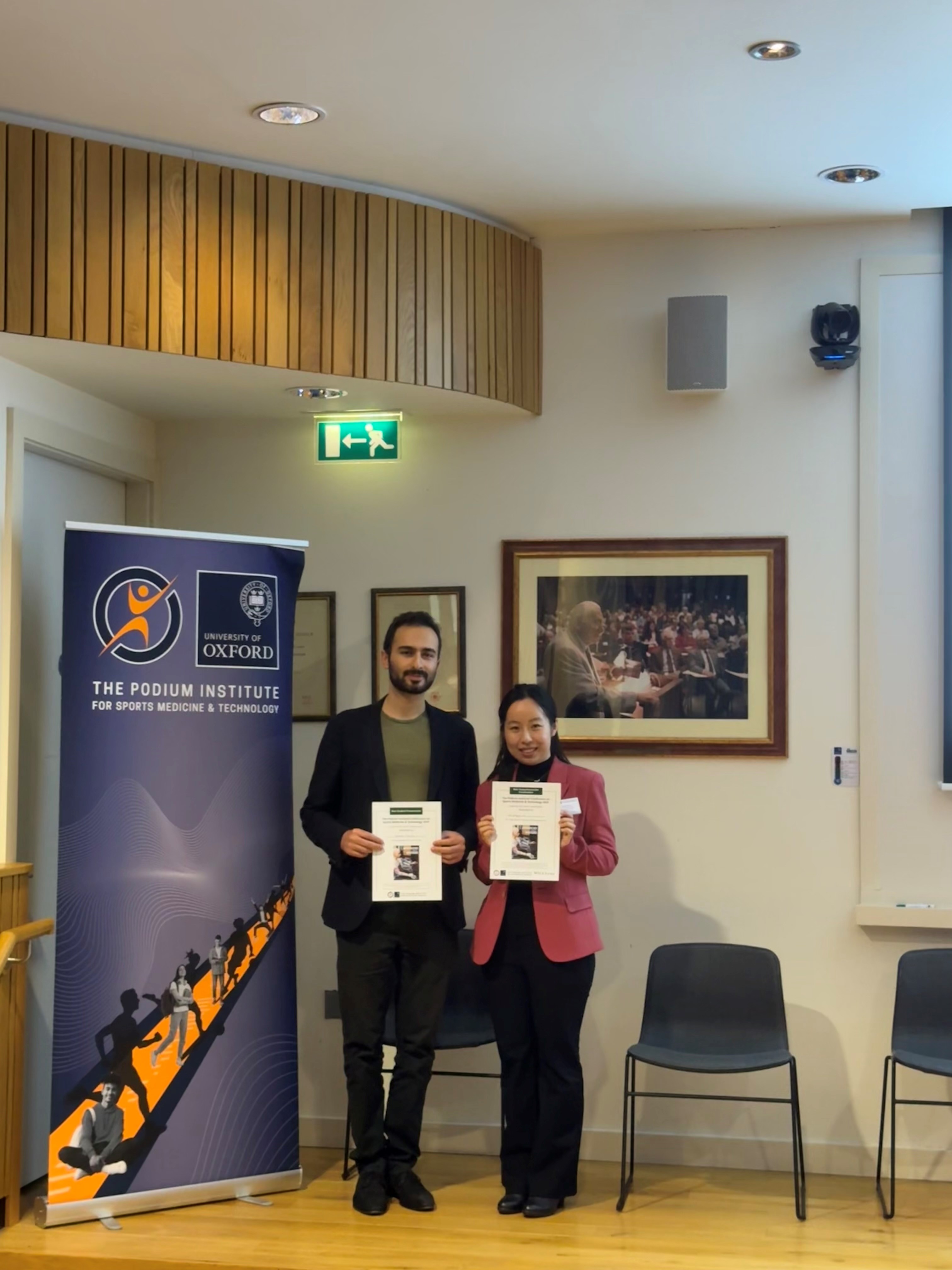 Konstantin Dzavaryan and Dr Chenying Liu holding awards from the Podium Institute Annual Conference on Sports Medicine & Technology 2025. Photo: Chenying Liu.