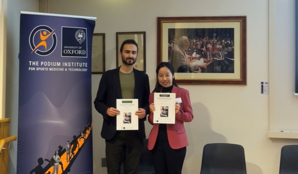Konstantin Dzavaryan and Dr Chenying Liu holding awards from the Podium Institute Annual Conference on Sports Medicine & Technology 2025. Photo: Chenying Liu.