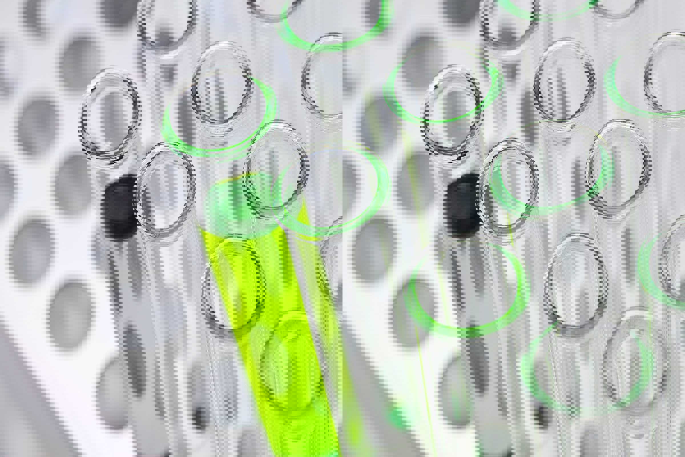 Test tubes, one with green liquid inside