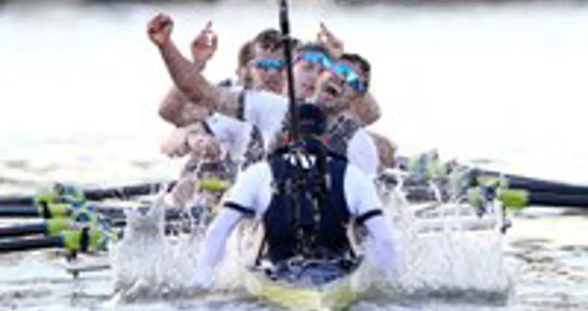 Photo of a team racing on a boat