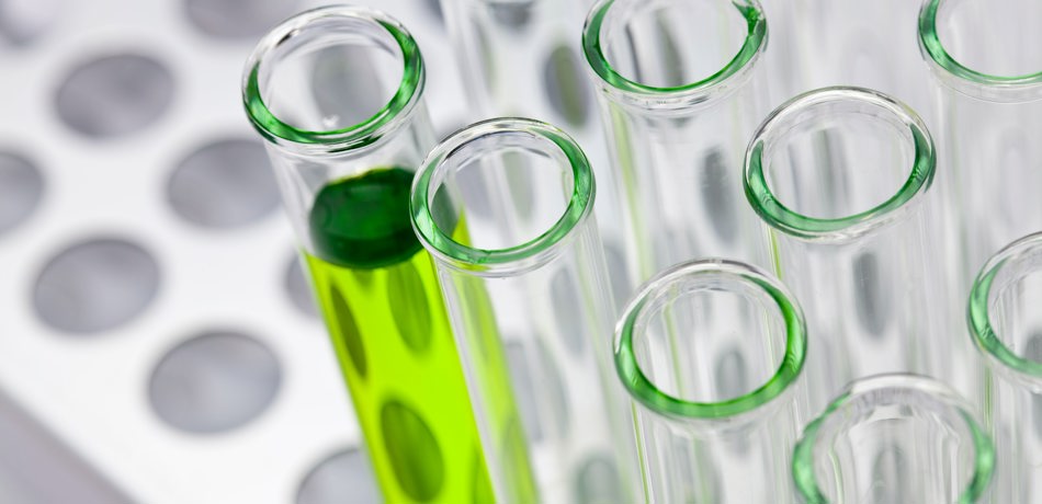 Test tubes, one with green liquid inside