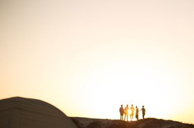 Stock image of group of people against light sky