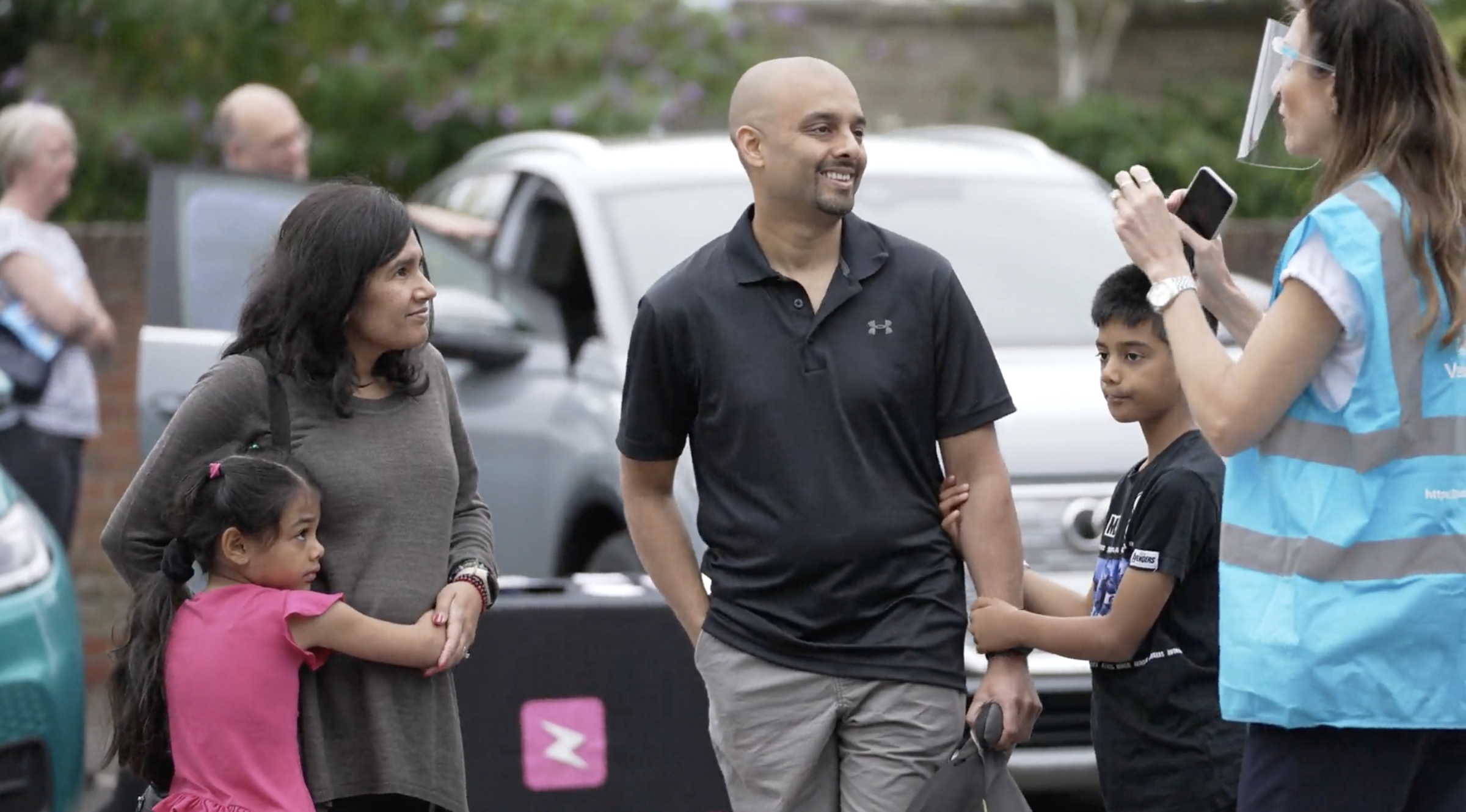 Group of people talking in car park