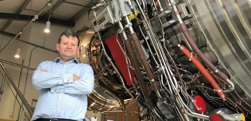 Mark Bacic in Thermofluids Institute with an aeroplane engine