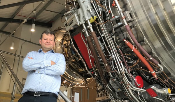 Mark Bacic in Thermofluids Institute with an aeroplane engine