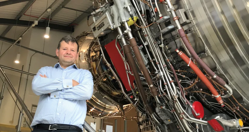 Mark Bacic in Thermofluids Institute with an aeroplane engine