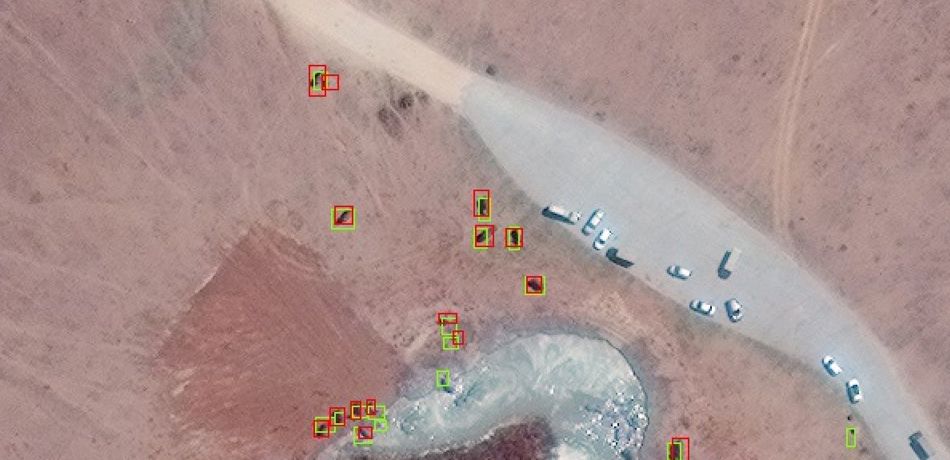 Example of CNN detections in Maasai Mara, Kenya from Geoeye‐1 Satellite, with CNN detections (green boxes) and ground truth labels (red boxes). Satellite image (c)2020 Maxar Technologies
