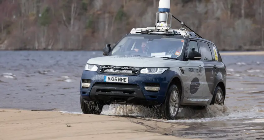 JLR driving through water in scotland.