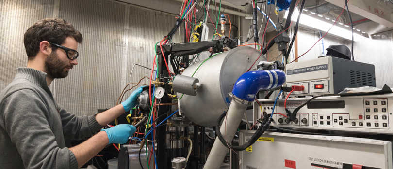 Researcher working on equipment in lab