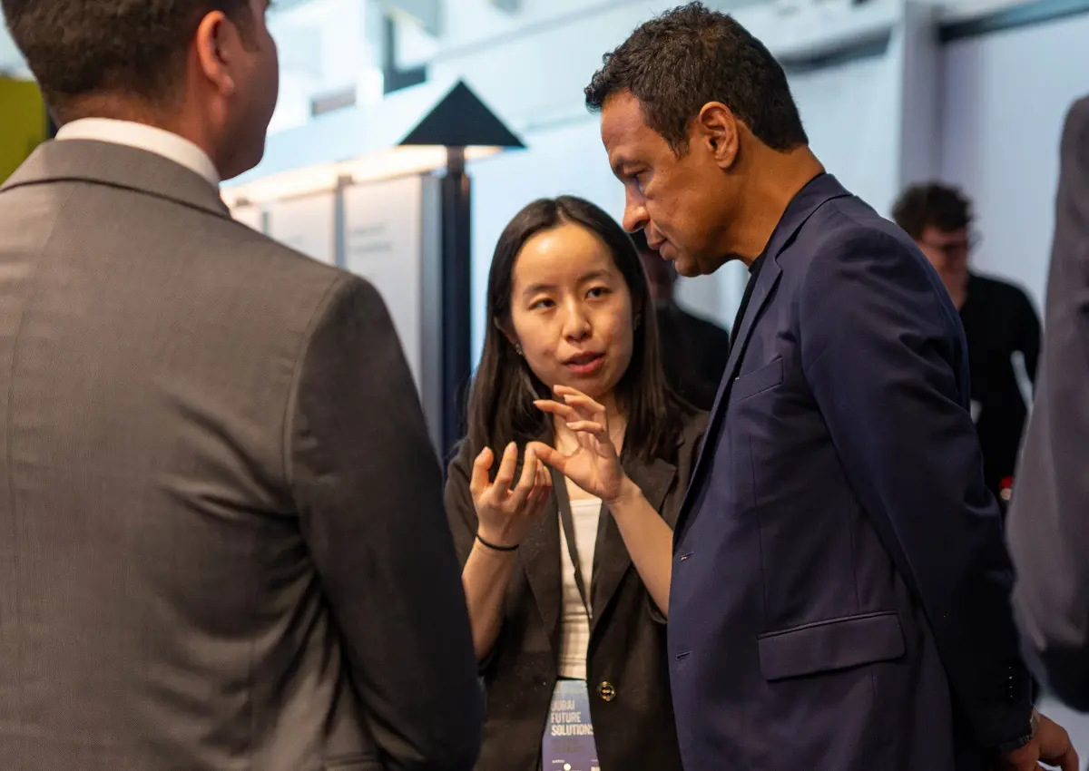 Dr Chenying Liu explaining her Prototypes for Humanity exhibit to visitors