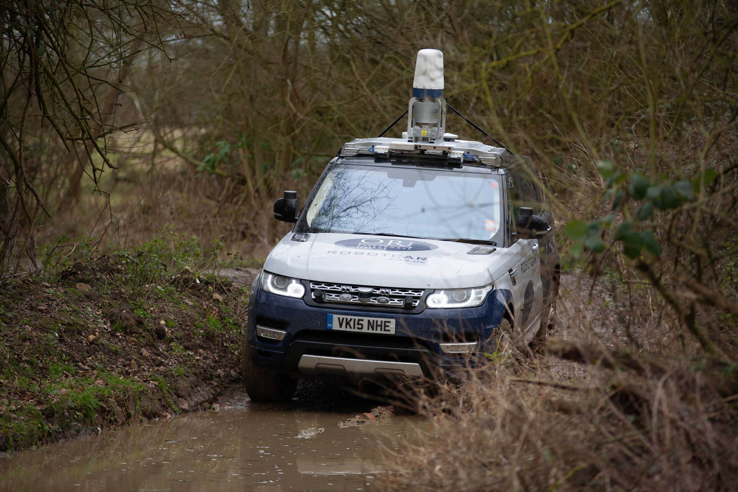JLR vehicle driving through water.