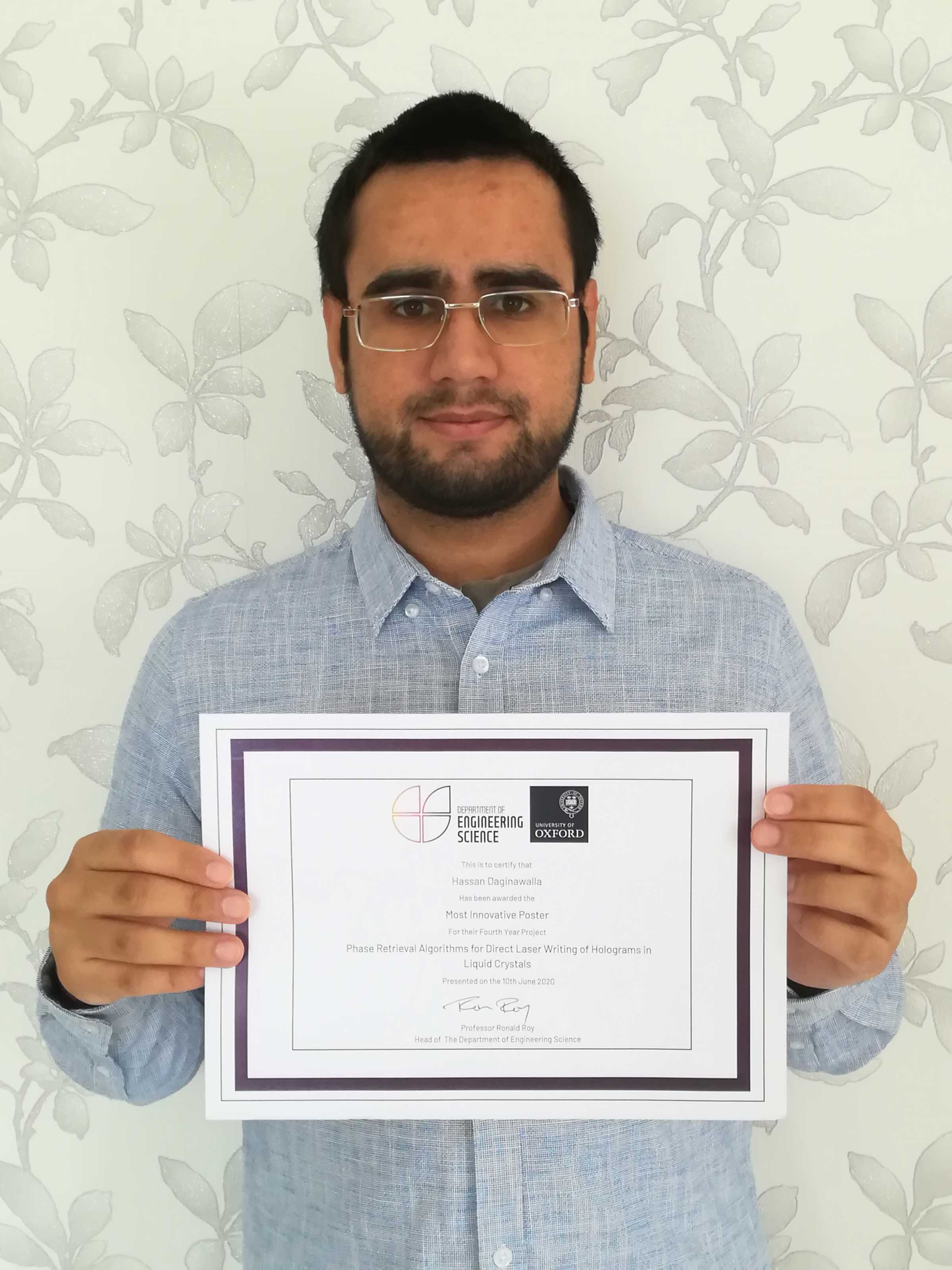 Hassan Daginawalla holding his Poster Prize certificate