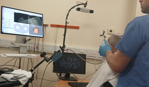 Participant undergoing TUS while carrying out a reaction-time test.