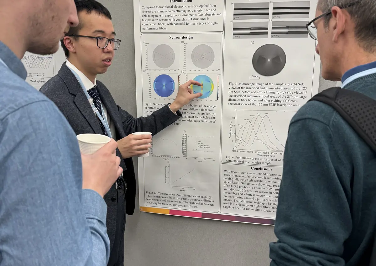 Tongyu Liu - man with East Asian appearance, presenting to two white men.