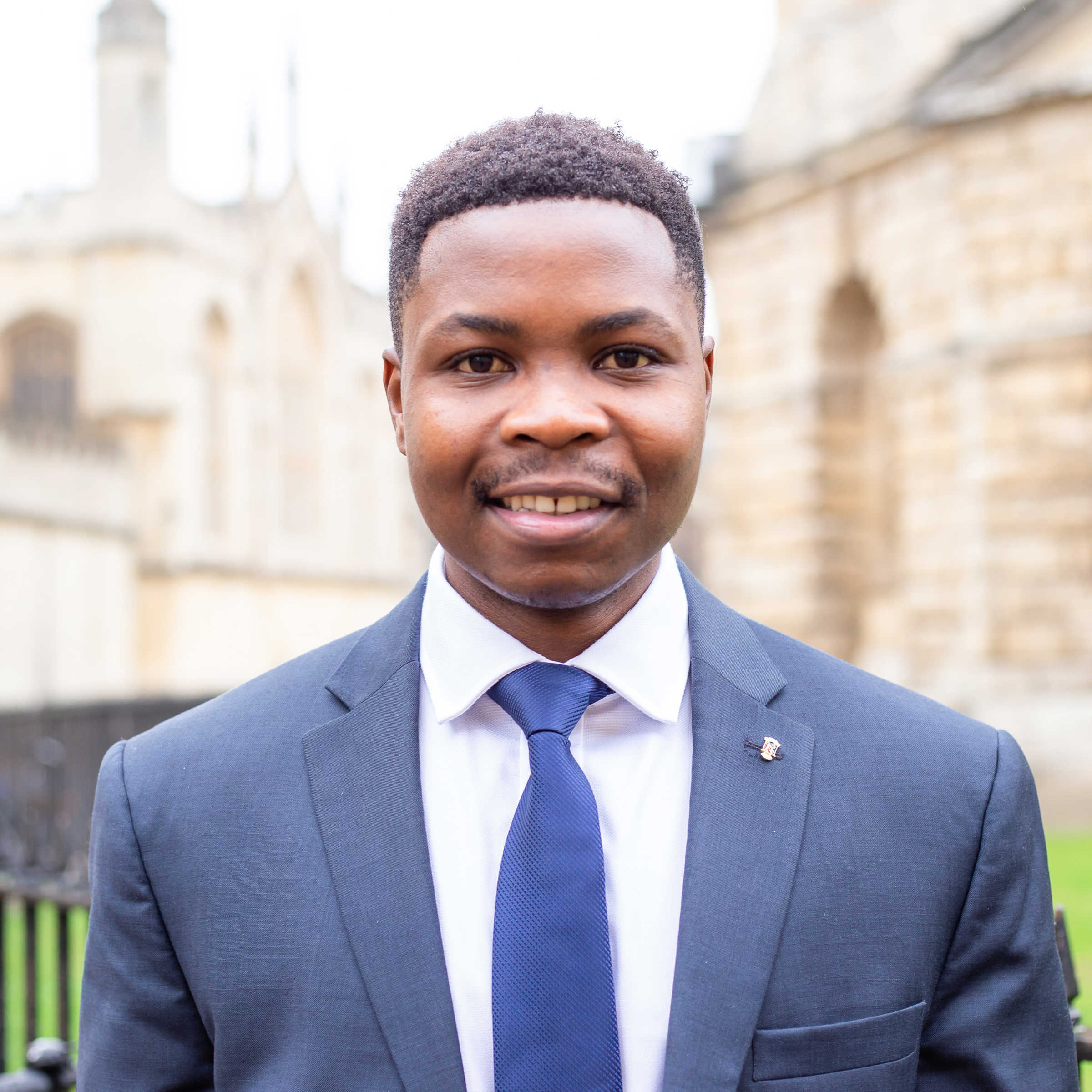 Young man smiling in suit