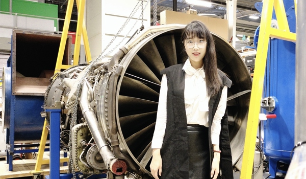 Muting Hao: a photo of Muting, an East Asian woman, standing by a turbine.