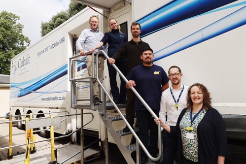 Members of the Cobalt Health and Philips MRI Imaging Scanner team on the steps of a mobile scanning unit in on 8 August 2025