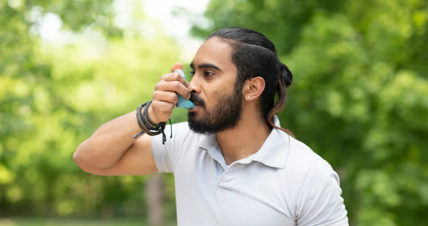 Man uses asthma inhaler 