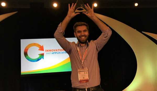 DPhil student Cristian Soitu holding aloft his trophy from the SLAS 2019 Conference