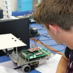 Student looking at robot
