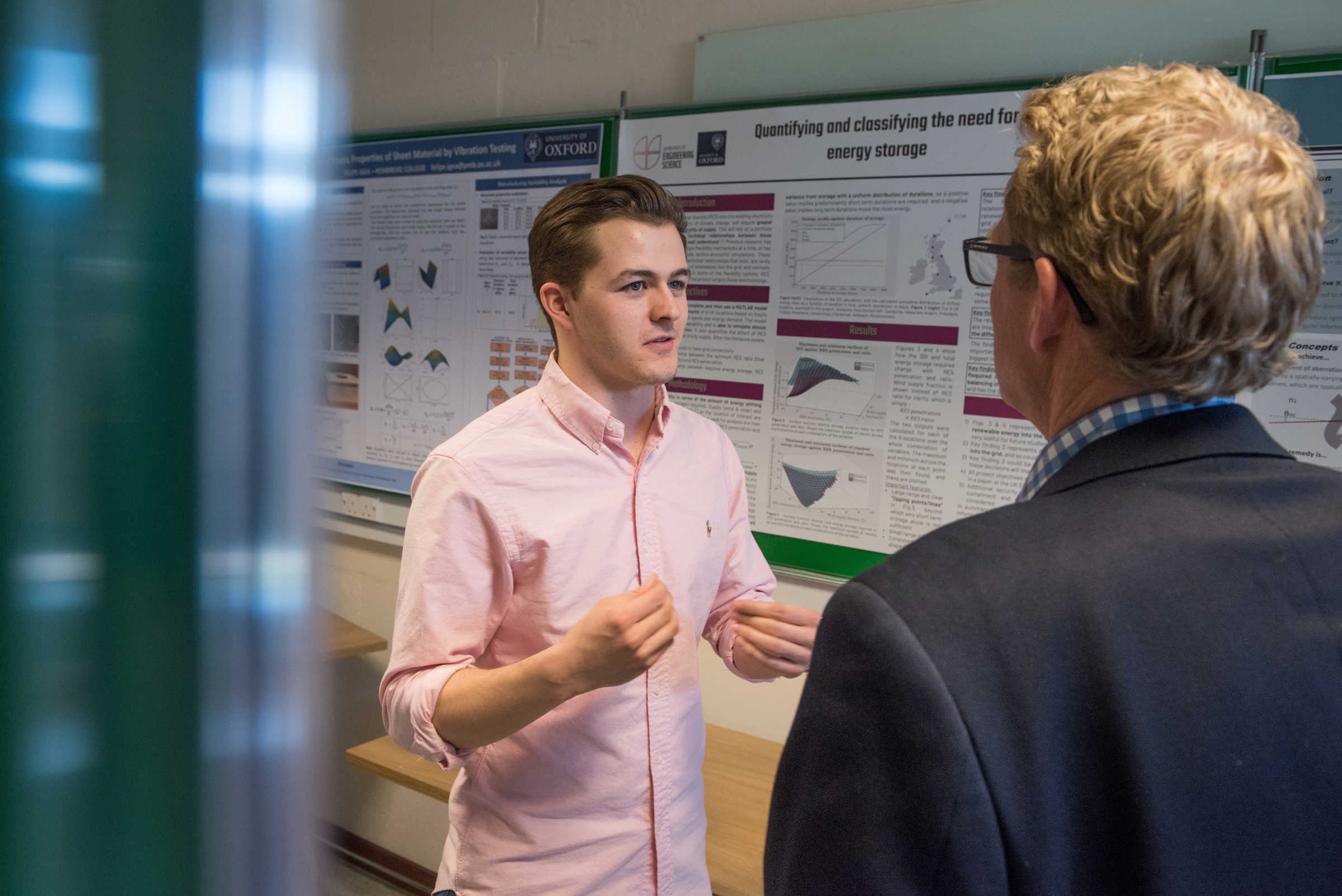 4th year student discussing his poster 