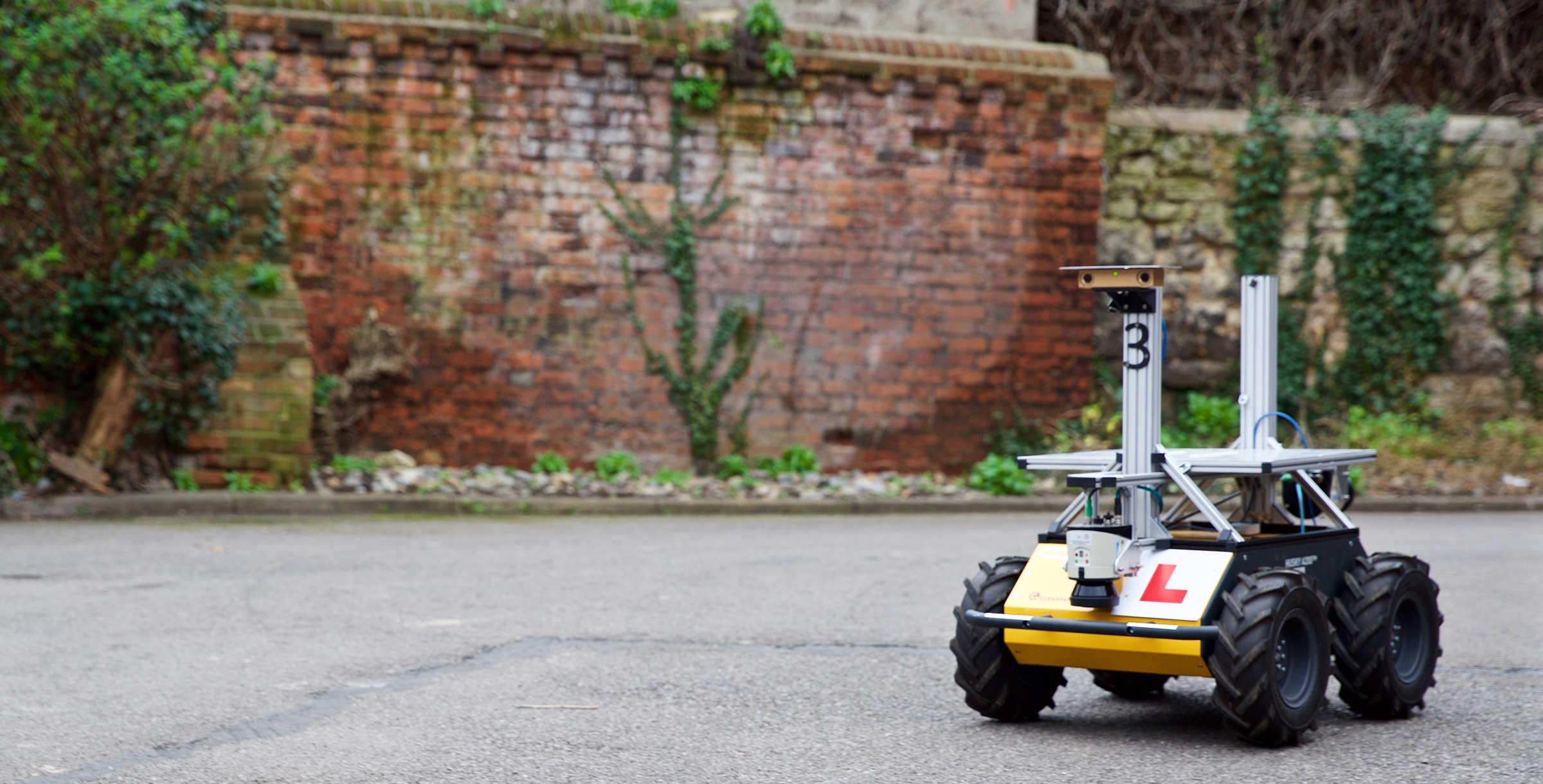 Husky robot displaying Learning plate on street. 