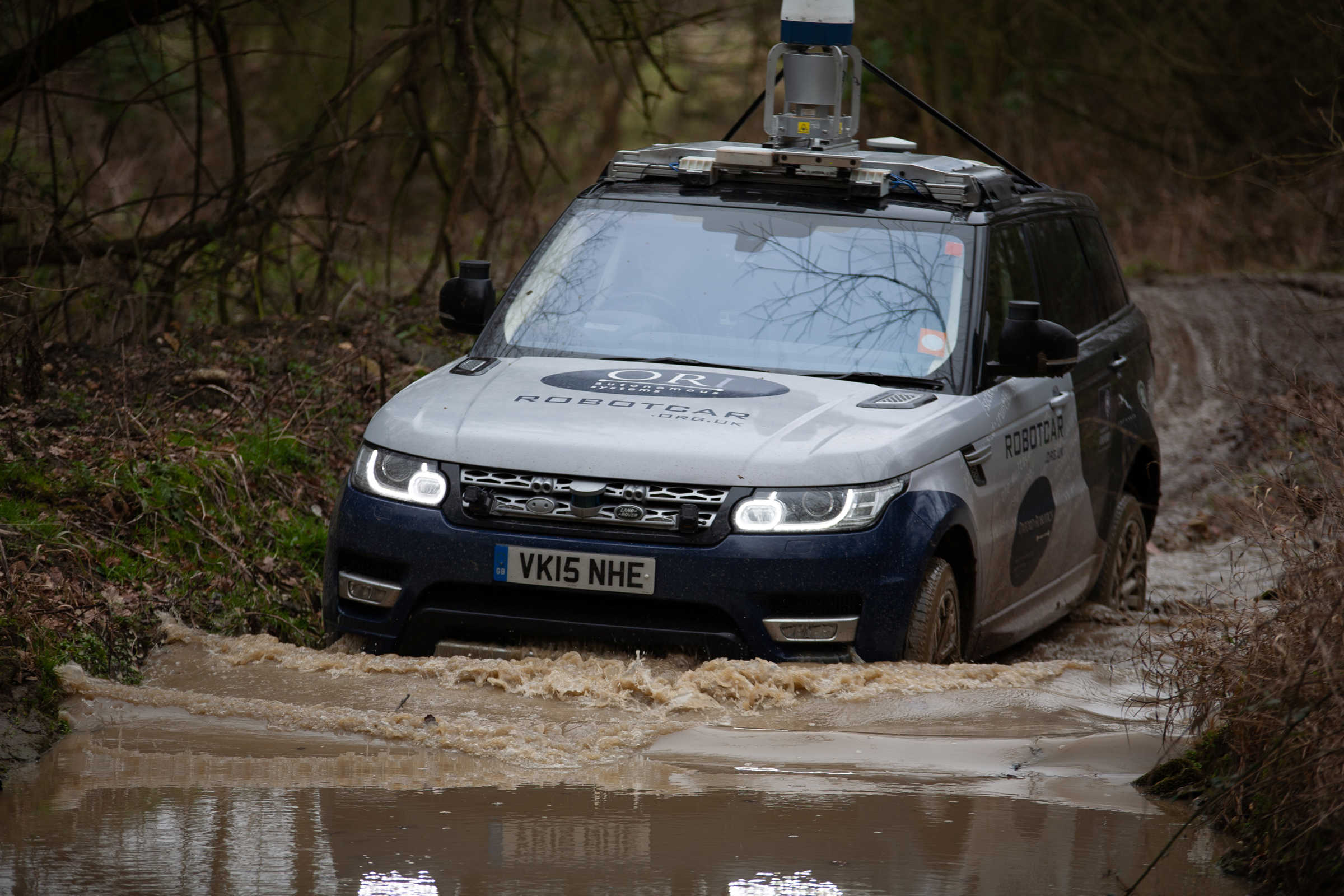 JLR vehicle driving through water.