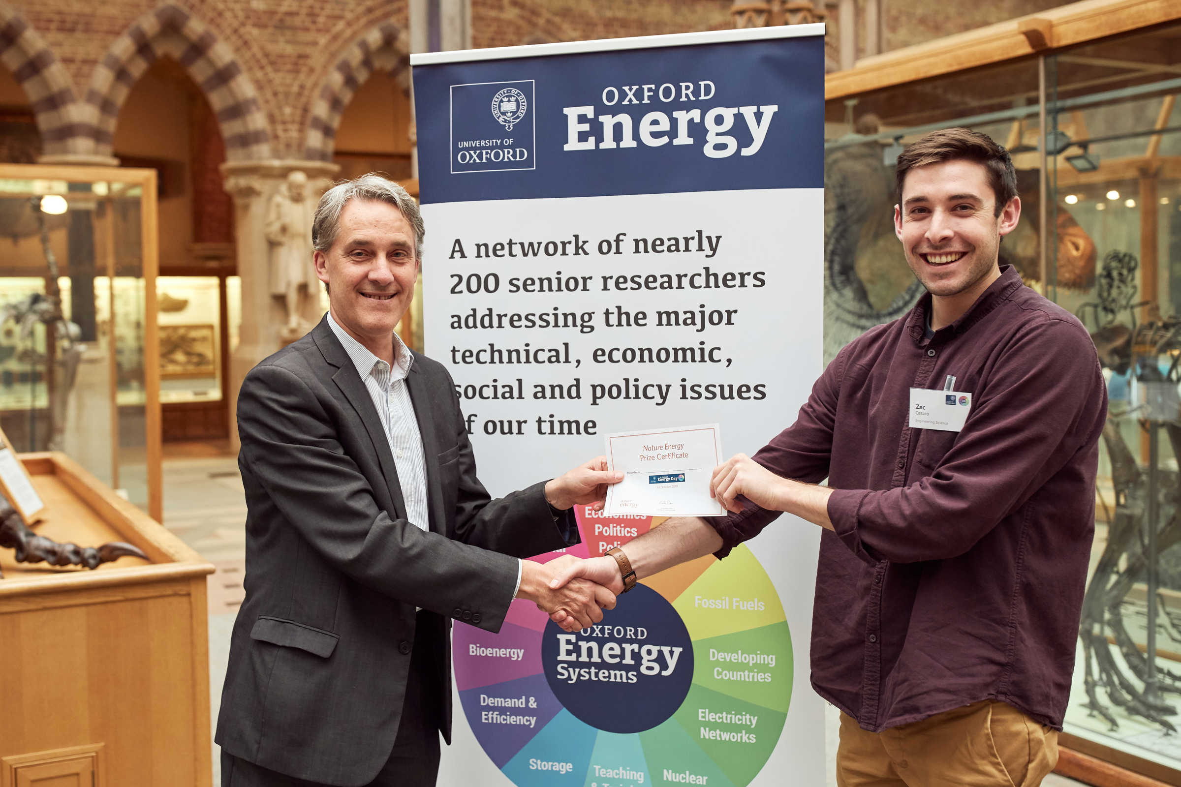 Zac Cesaro receiving his best poster award from Professor Nick Eyre at 8th annual Oxford Energy Day conference in 2019