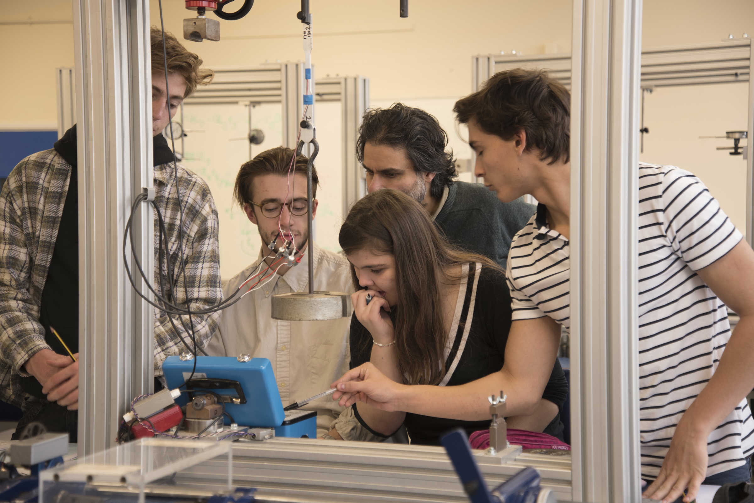 Group of students around experiment involving weights