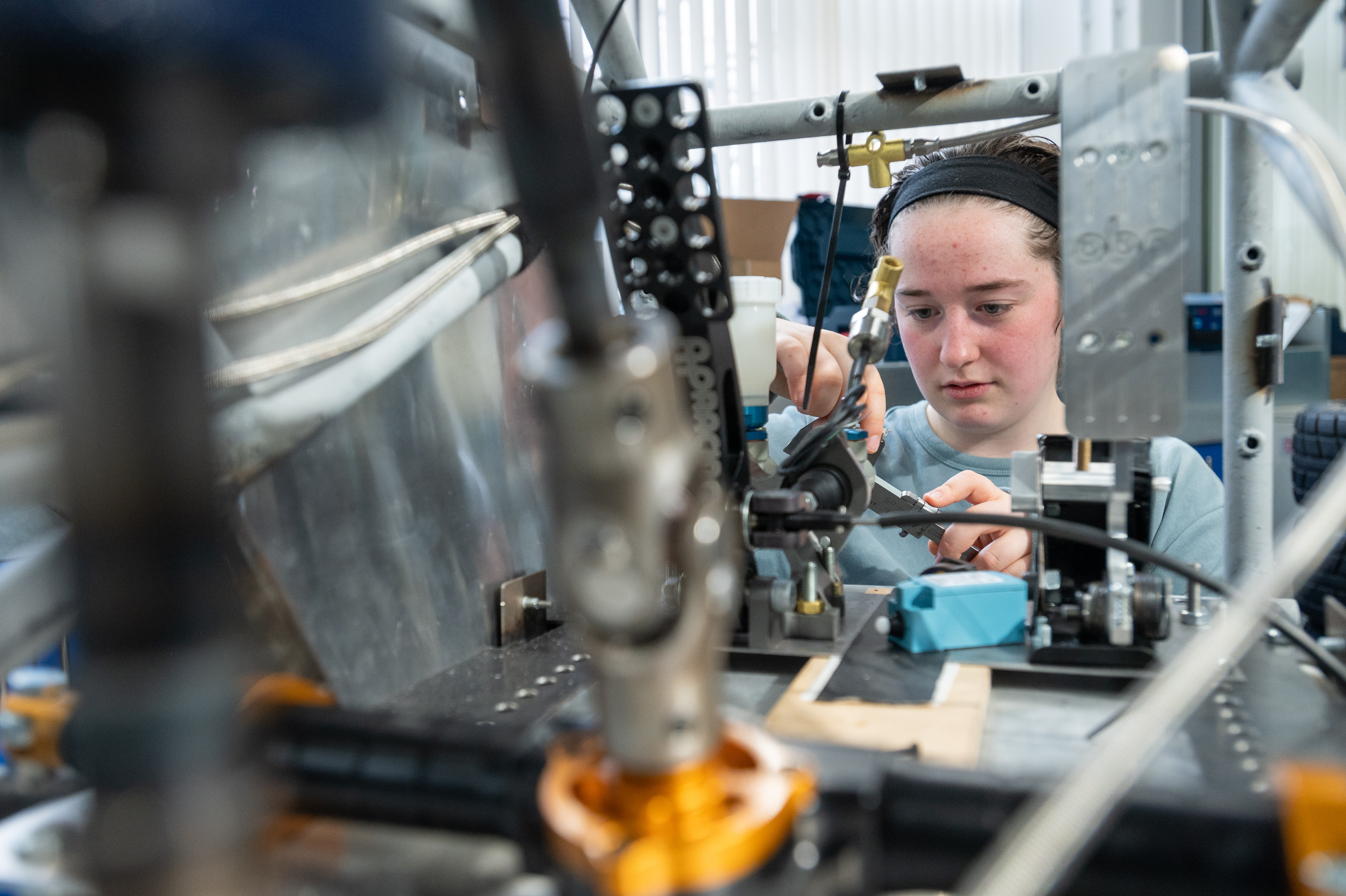 Student working on equipment in the Oxford University Racing lab
