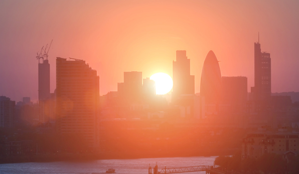 Sun rises over London buildings along the Thames