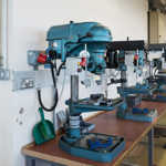 Row of several large drilling machines in a lab