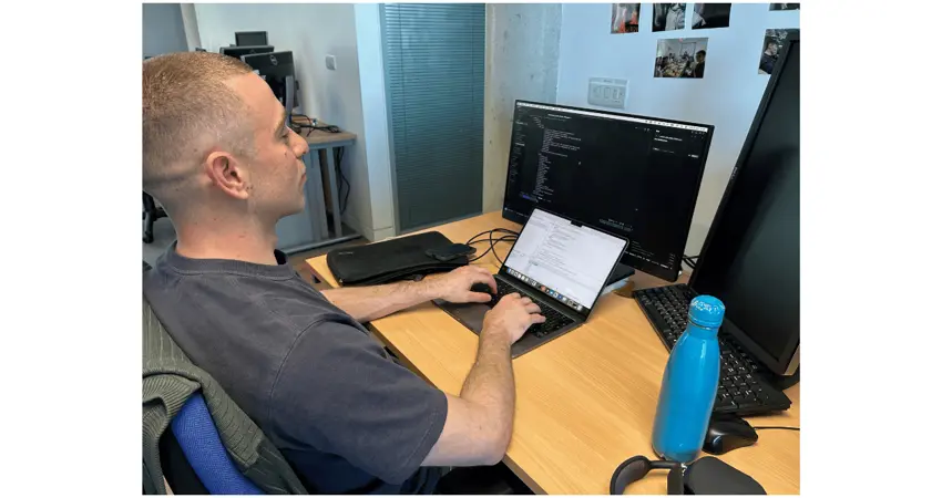 Power Systems Architecture Lab member working at laptop during Worldwide Quantum Hackathon