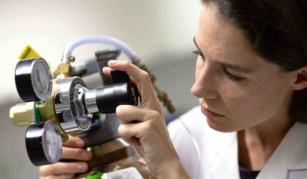 Professor Eleanor Stride with biomedical engineering equipment