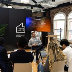 Bradley Segal's chosen profile picture, lecturing in front of 5 people.