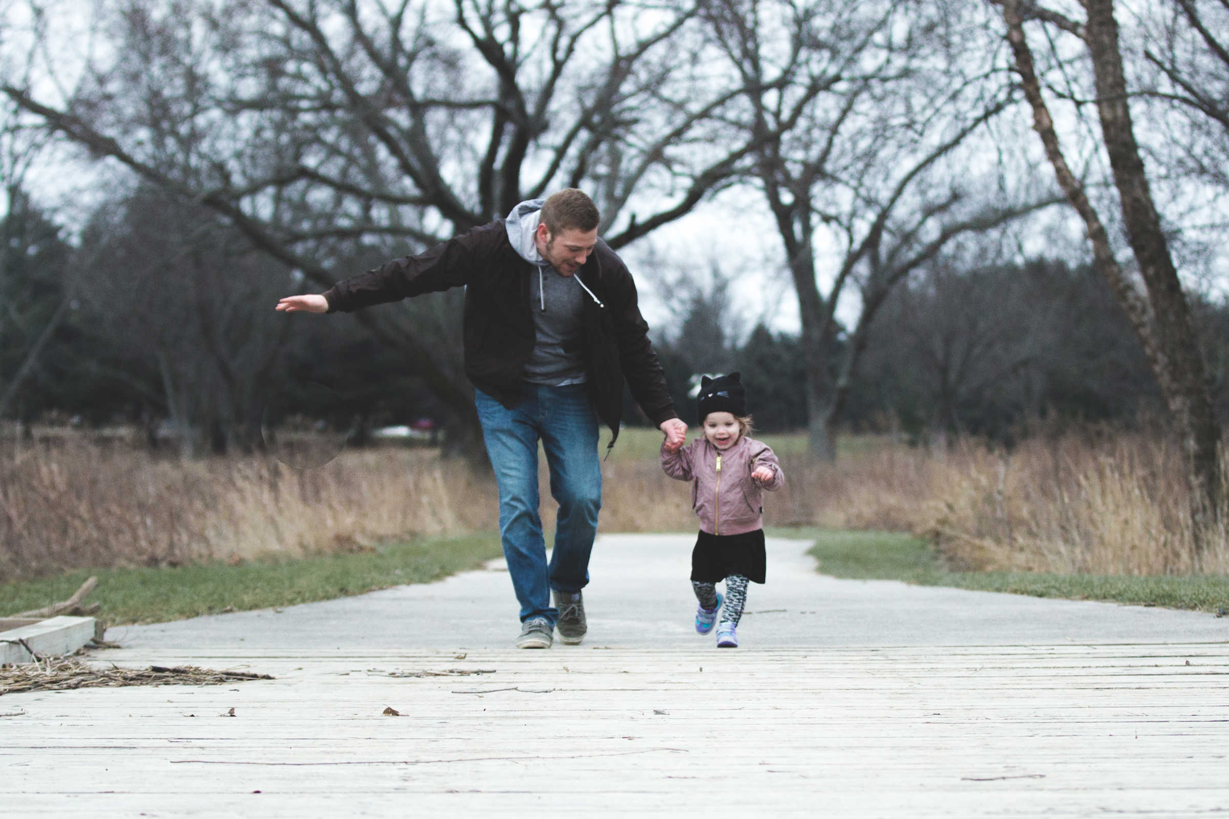 Father and young child out for a walk in autumn