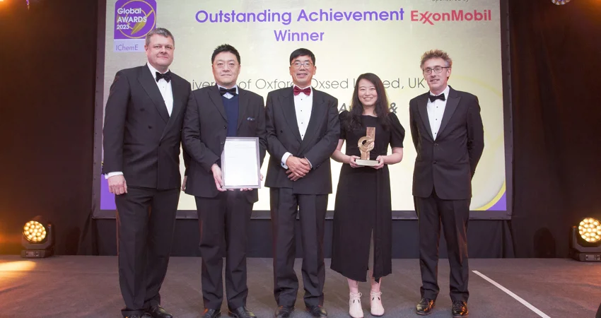 IChemE Awards Outstanding Achievement Winners Oxsed: two white men - far left and far right; two East Asian men - second from left (holding the framed certificate) and centre; one East Asian woman (holding the award statue).