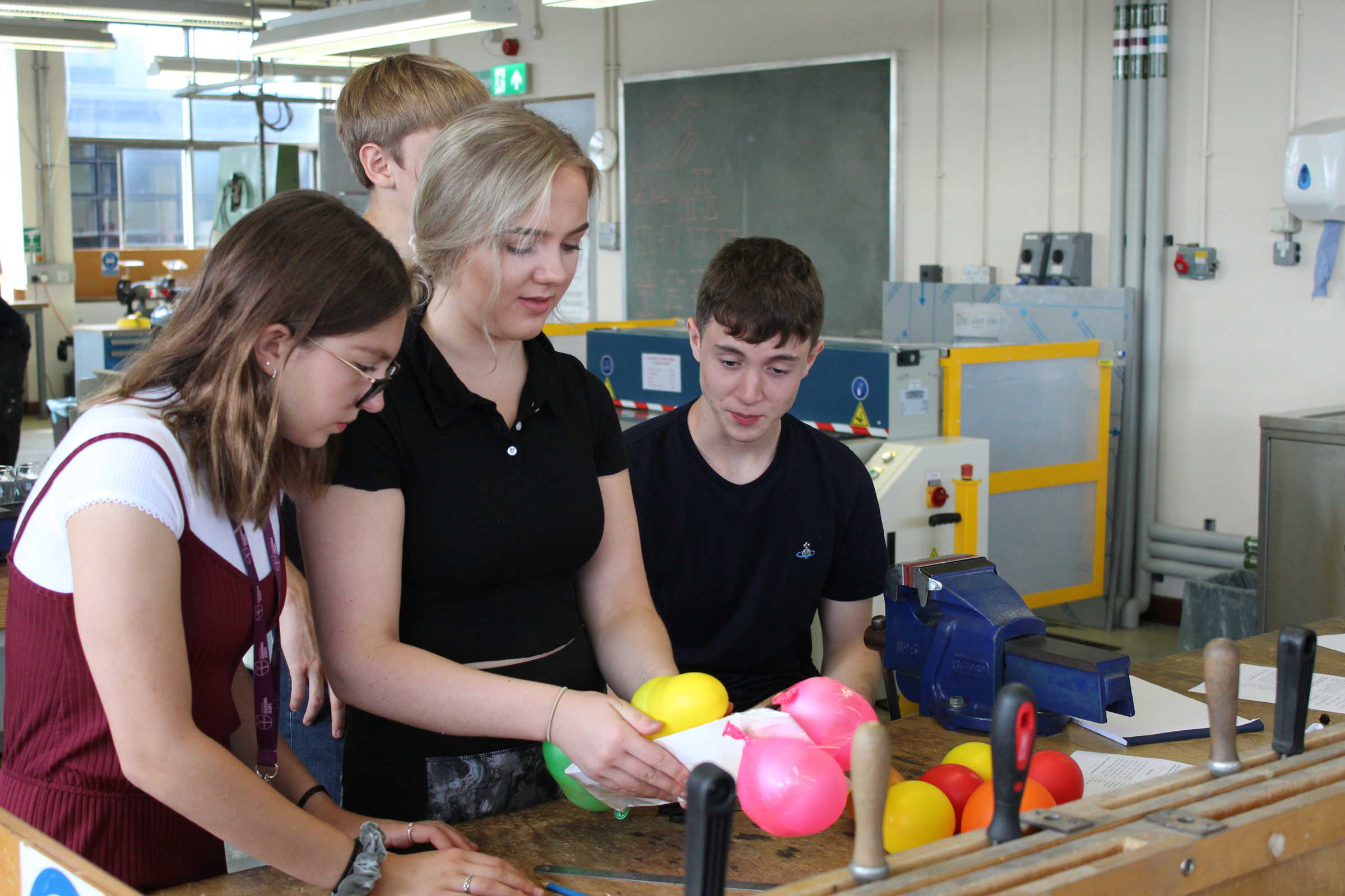School students in workshop using balloons
