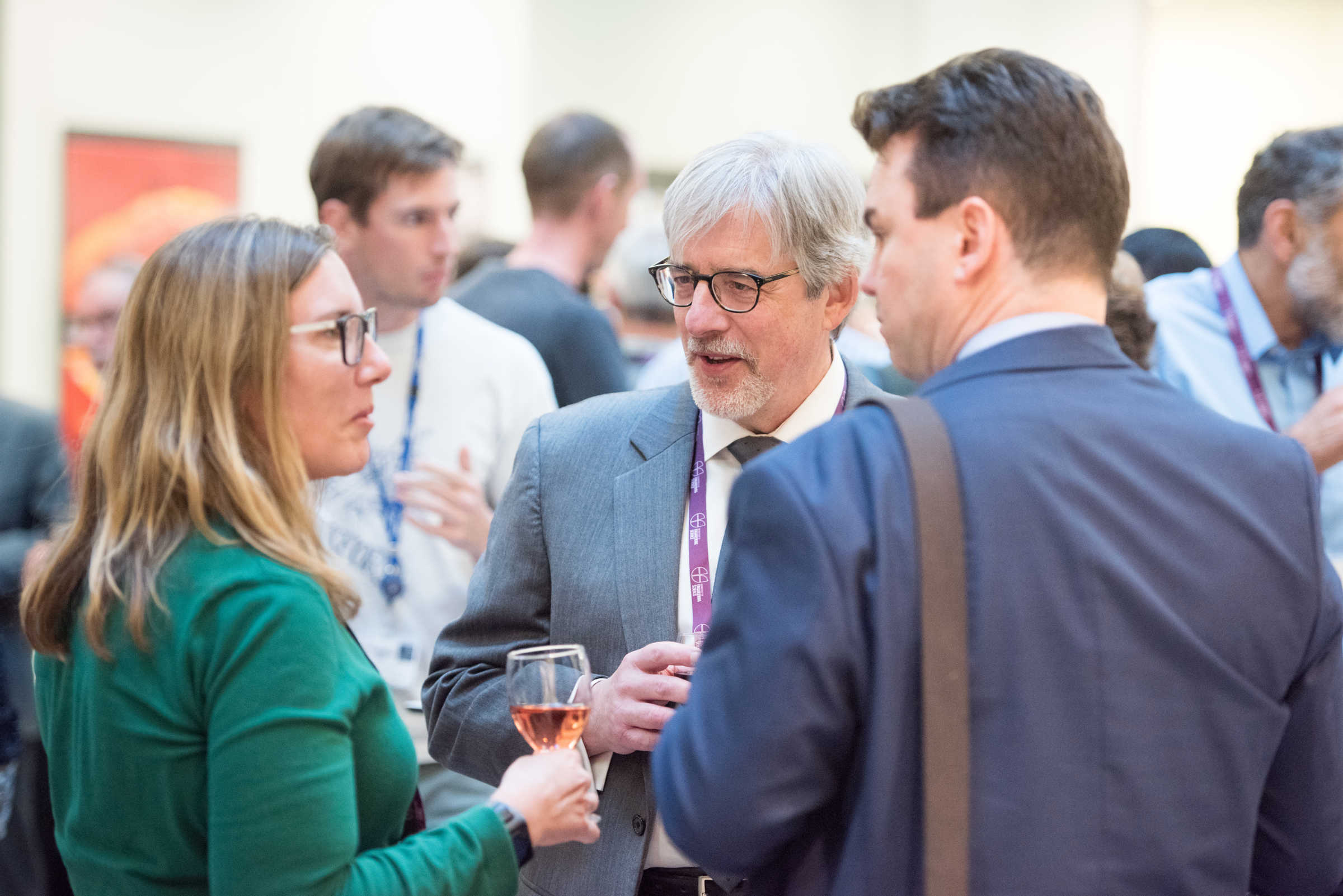 Professors Ron Roy and Constantin Coussios with alumna at an event